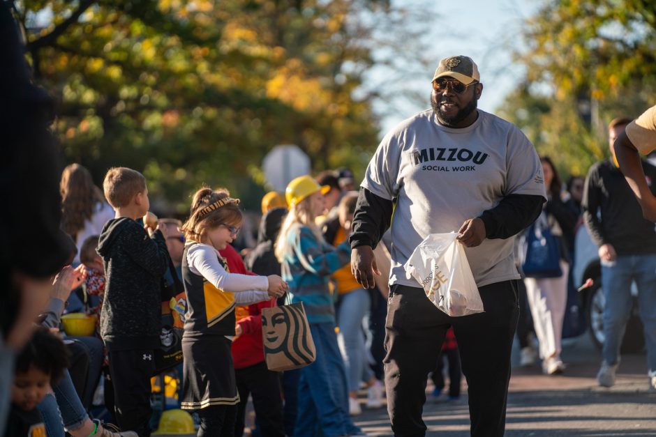 Man wearing Mizzou shirt passes out candy