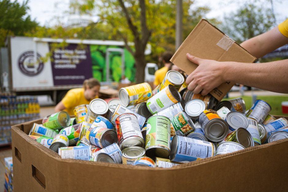 Close-up of hands sorting canned food