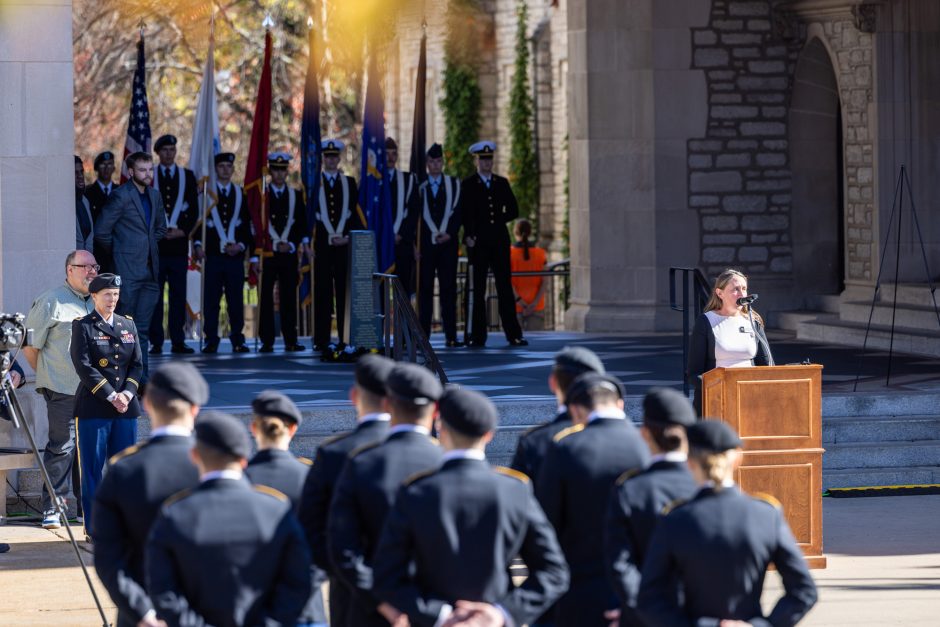 Woman speaks at podium during ceremony