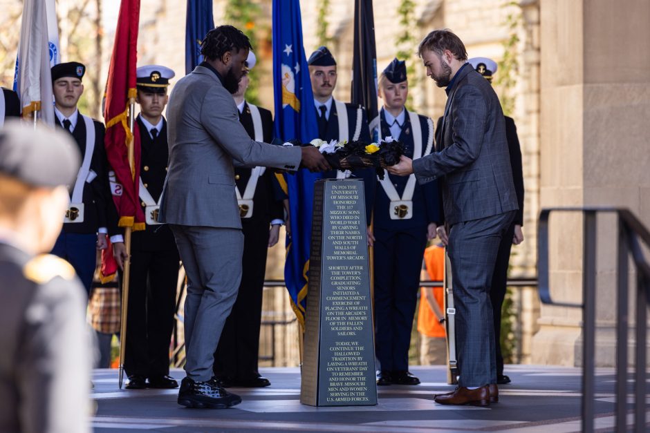 People laying wreath at ceremony