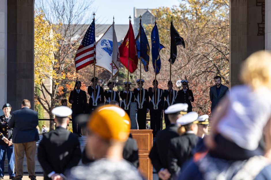 Service members hold flags