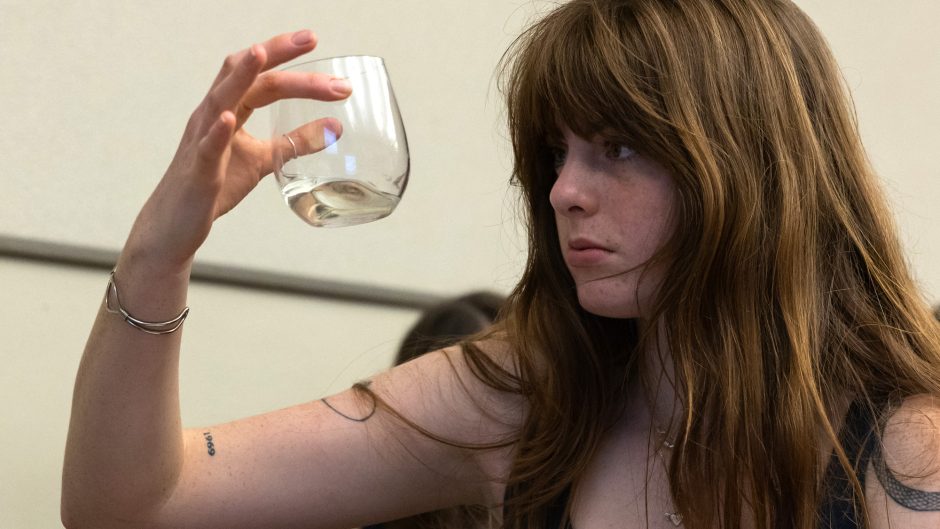 A student holds a glass