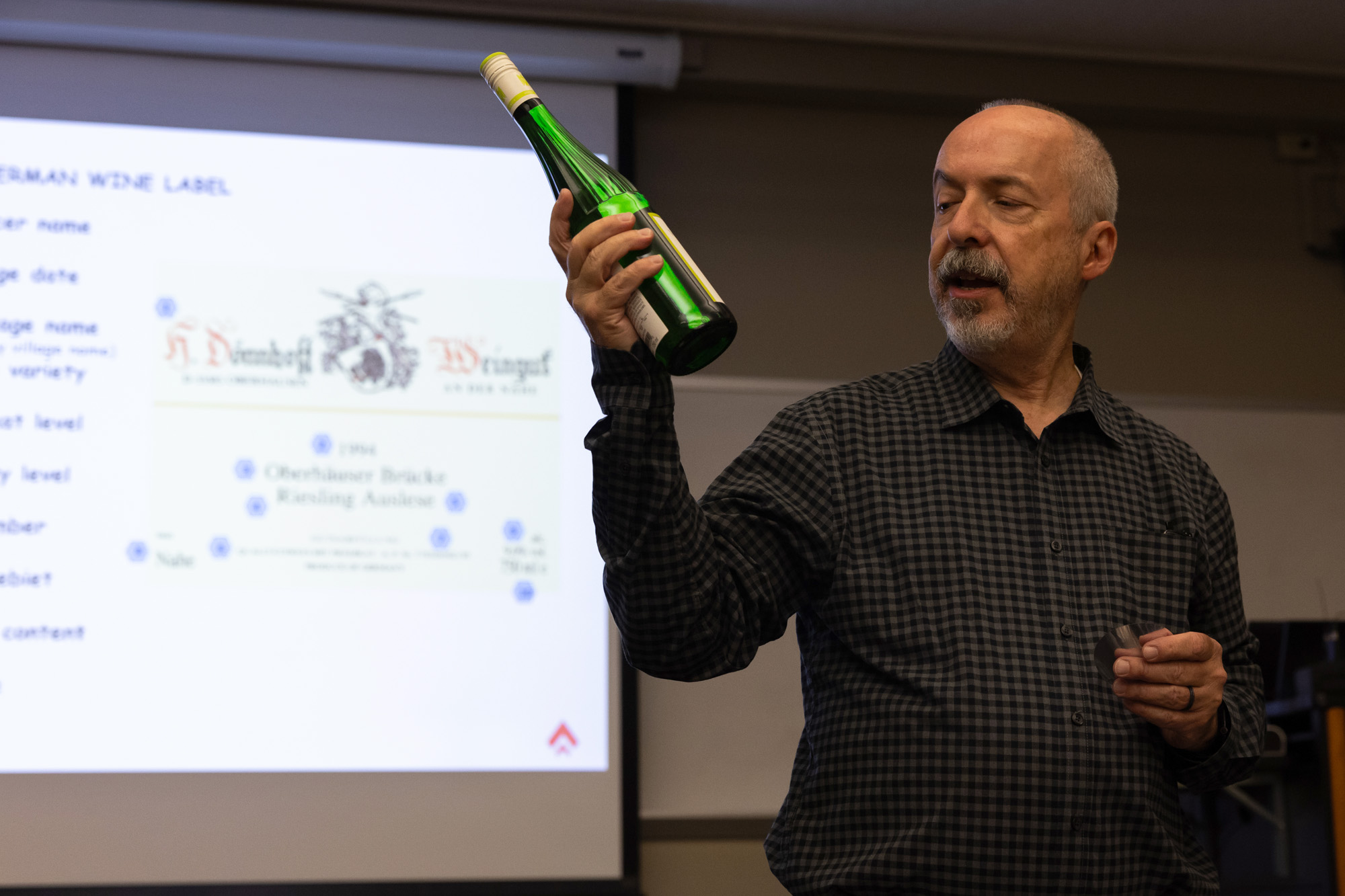 Mike Ward holds a bottle of wine