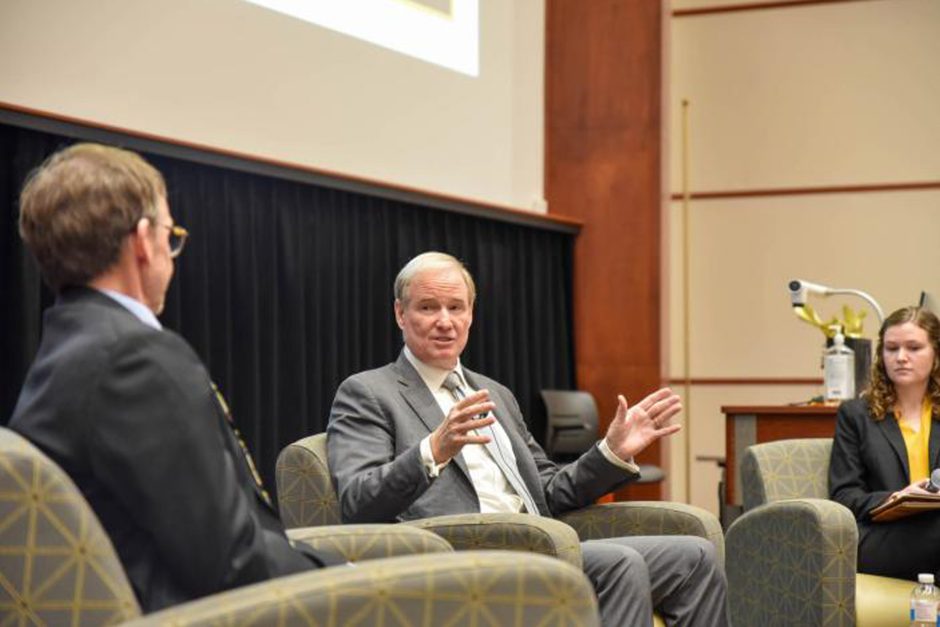 Patric Walsh, seated, speaks 