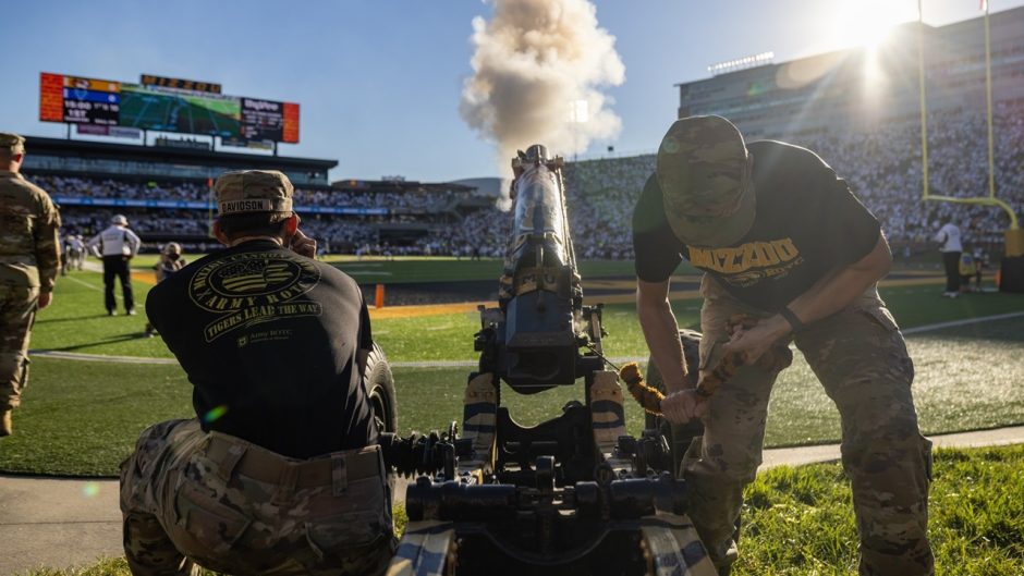 Mizzou ROTC cannon crew fires the cannon at a football game.