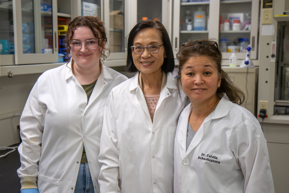 Three scientists in lab coat in lab