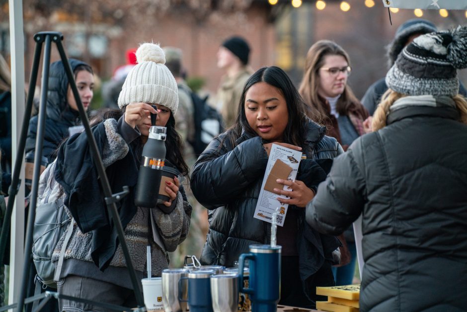 People pour drinks at outside event