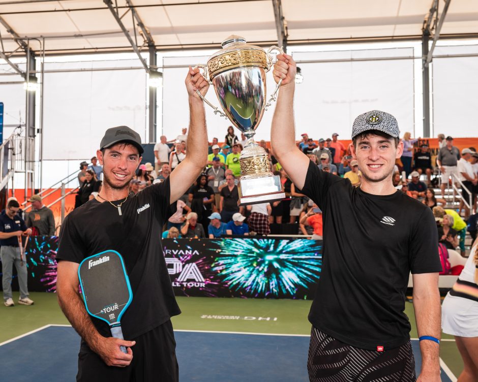 pickleball players holding trophy