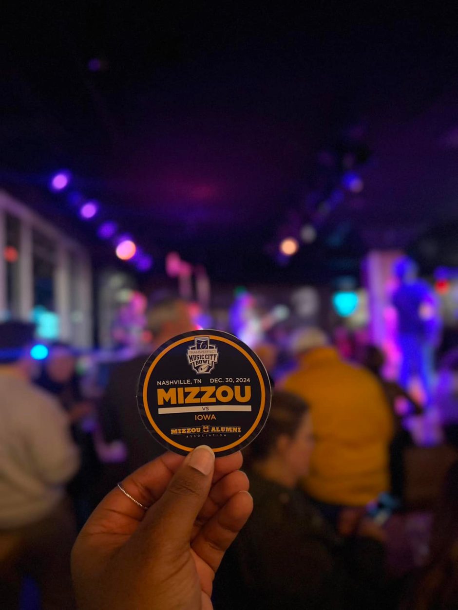 Hand holding Mizzou sticker