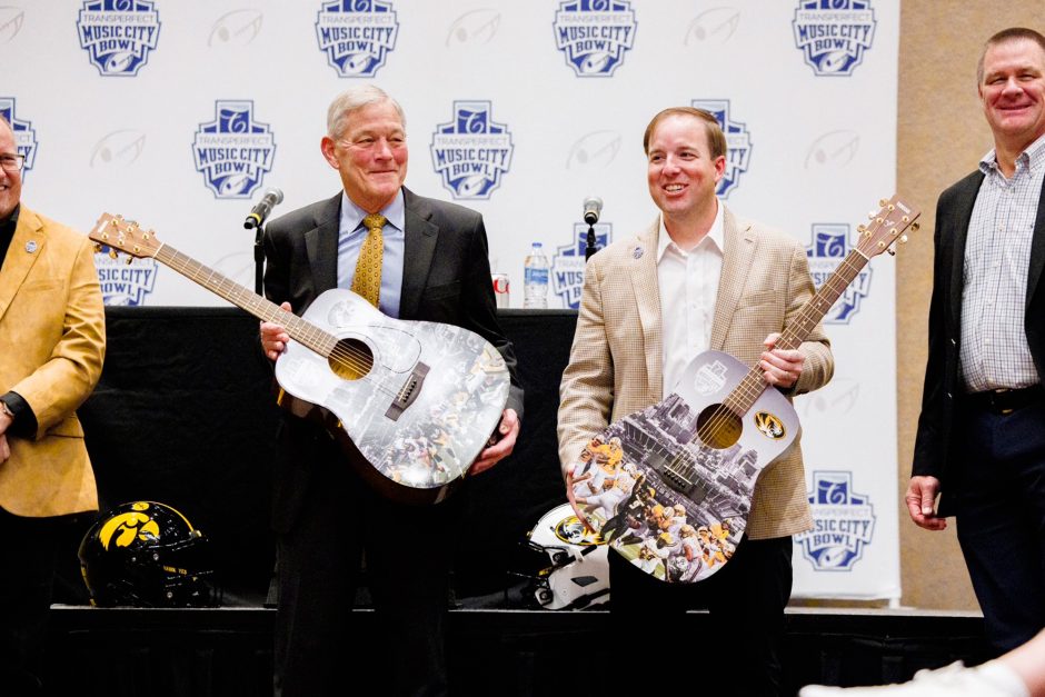 Two men holding guitars