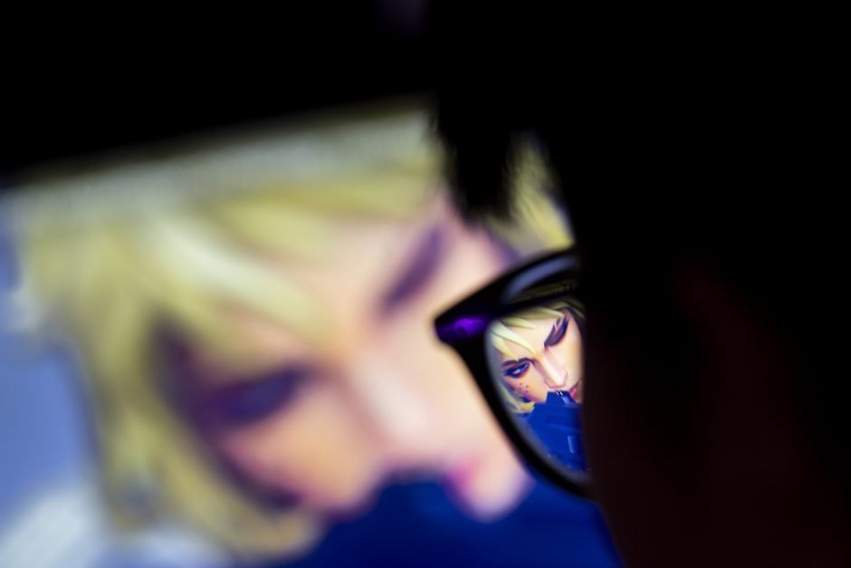 Video game avatar on screen and reflected in glasses