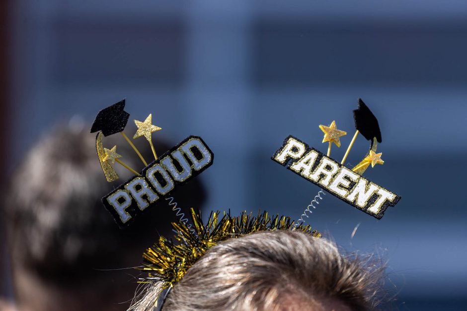 Top of head with headband that says "proud parent"