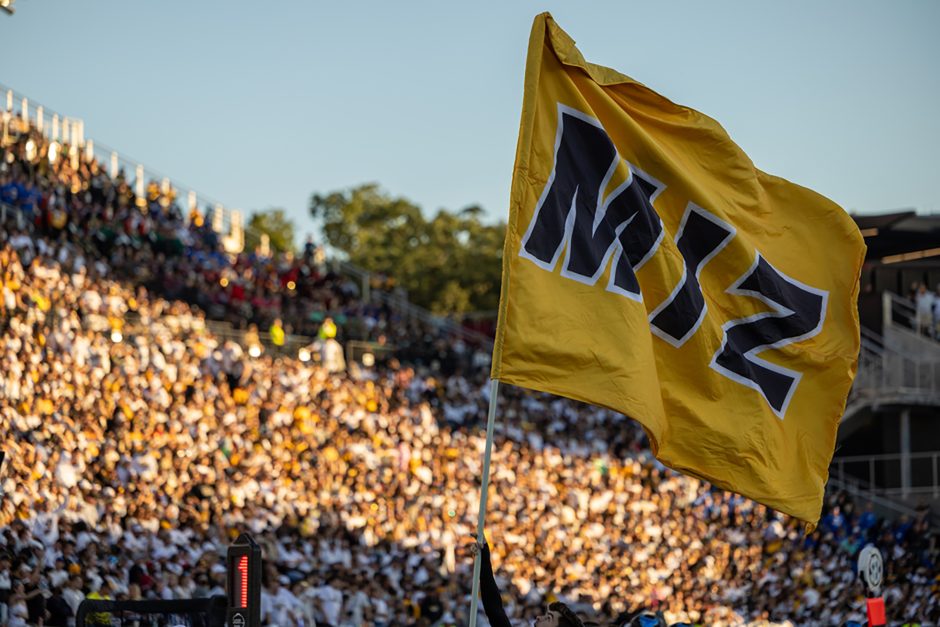 An MIZ flag waves at football game