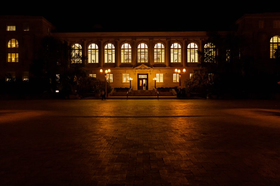 Person walks into well-lit library at night