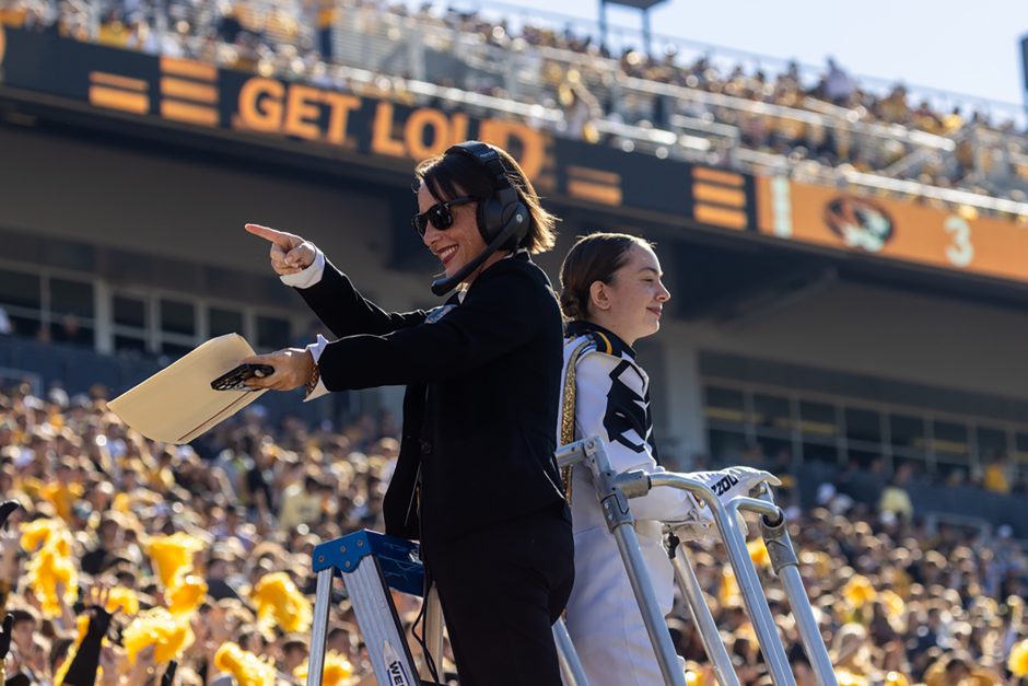 Conductor leads band during football game