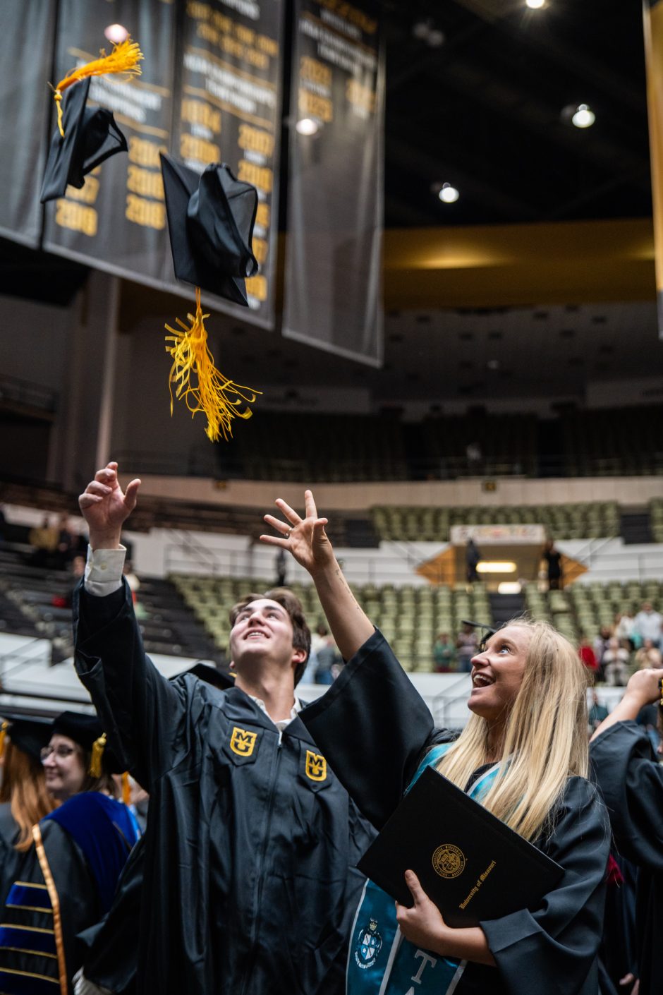 Graduates toss their mortar boards