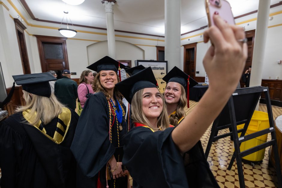 Graduate takes photo with friends