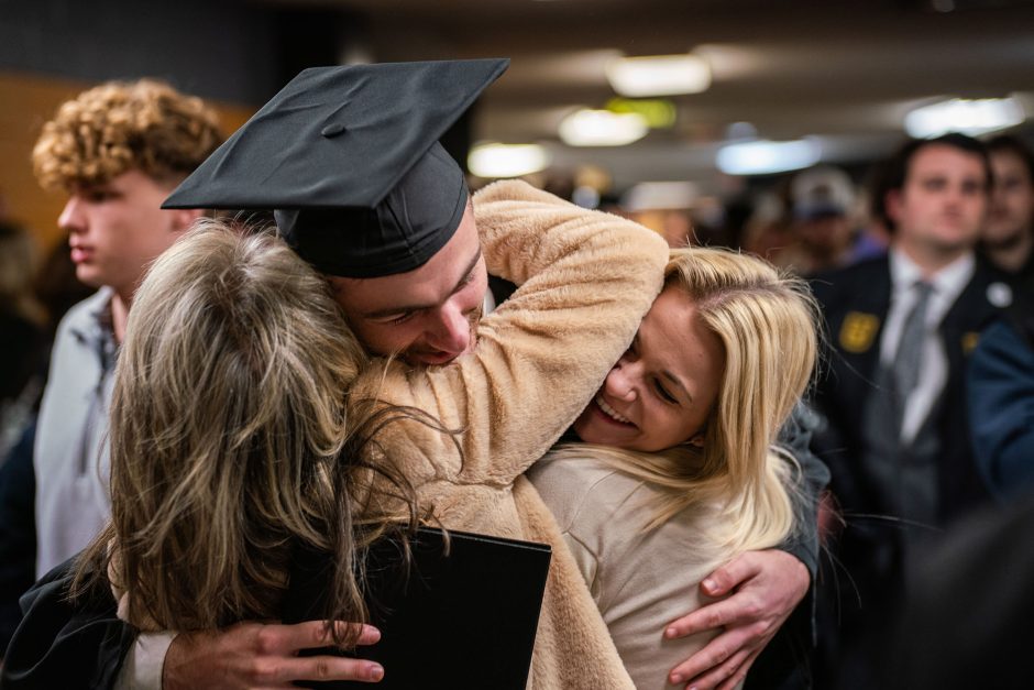 Graduate hugs friends