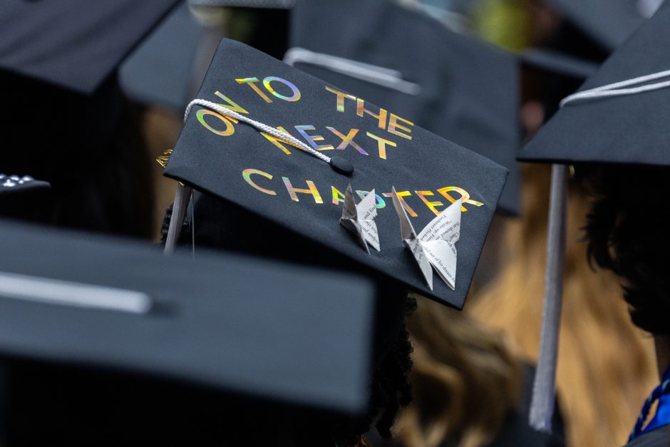 Mortar board decorated with "On to the next chapter"