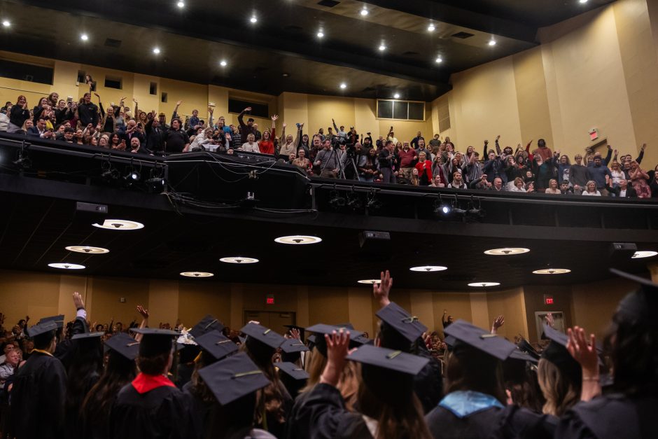 Graduates wave to family members