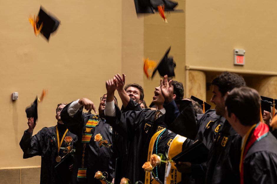 Graduates toss caps into air