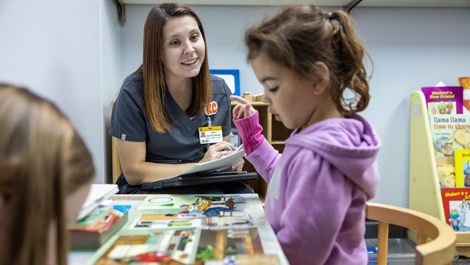 A Mizzou graduate student observing a child at the Child Develpment Lab.