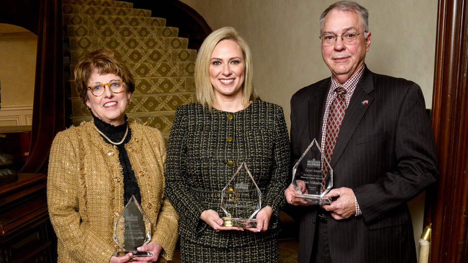 Three people with awards