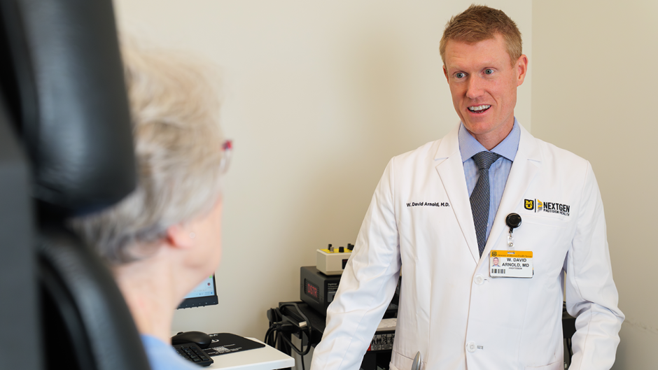 W. David Arnold speaking with a patient.