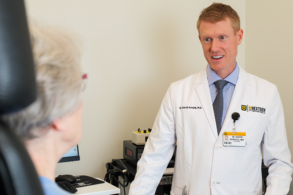 W. David Arnold talking to a patient.