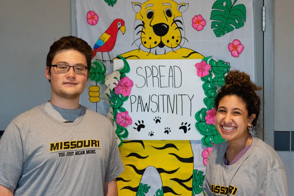 Two students with sign