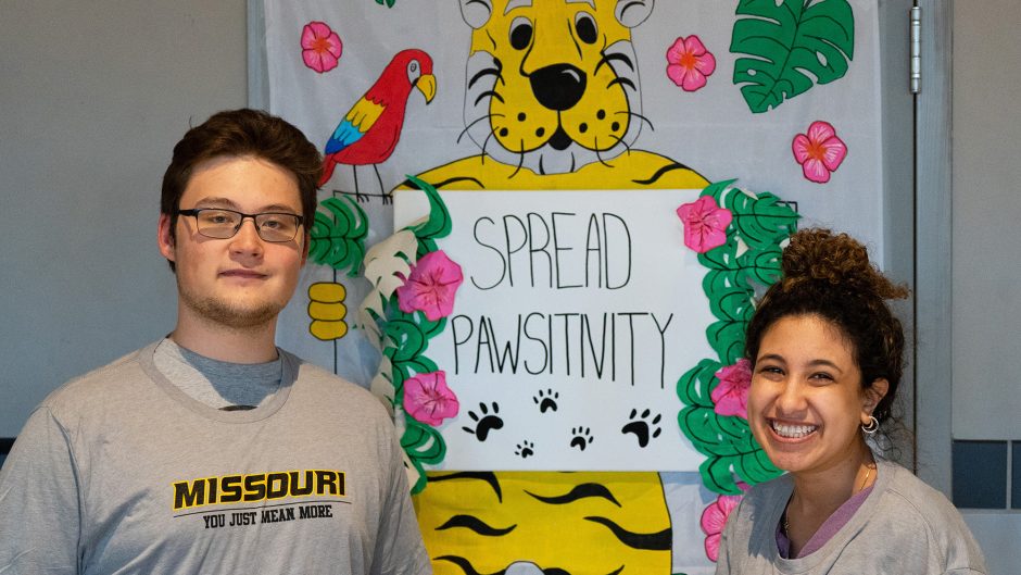 Two students with sign