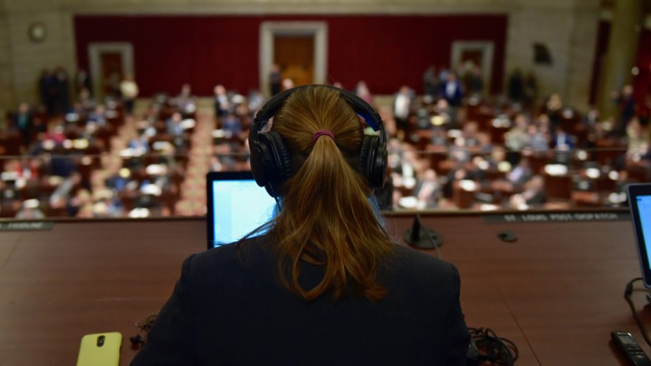 Back of reporter's head overlooking legislature