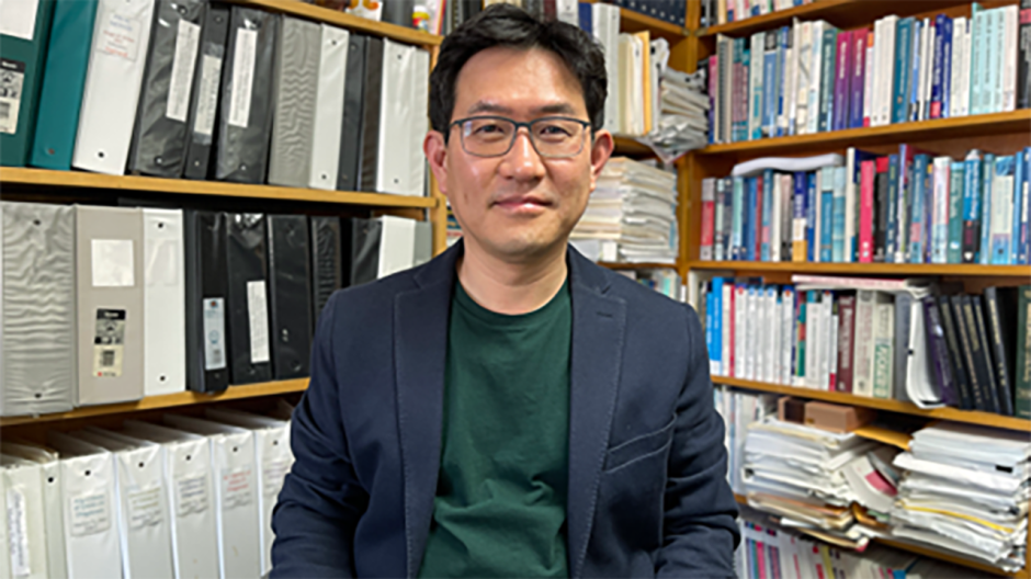 Mansoo Yu posing in his office.