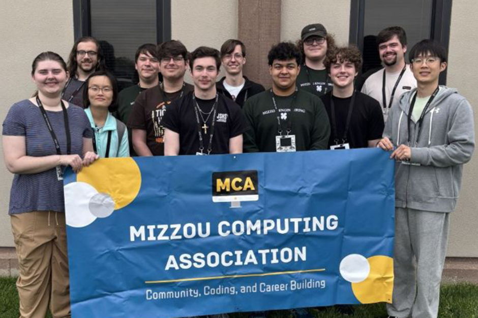 Group of students with Mizzou Computing sign