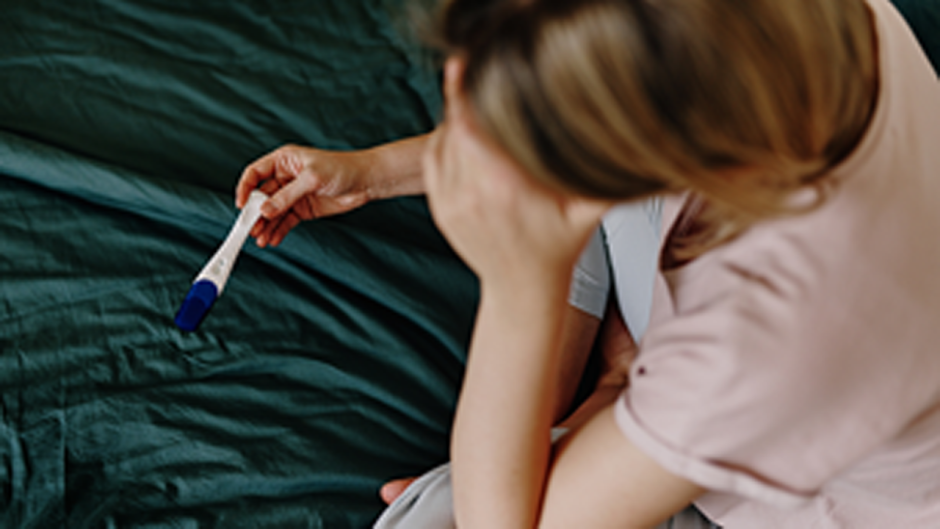 Woman looks at pregnancy test