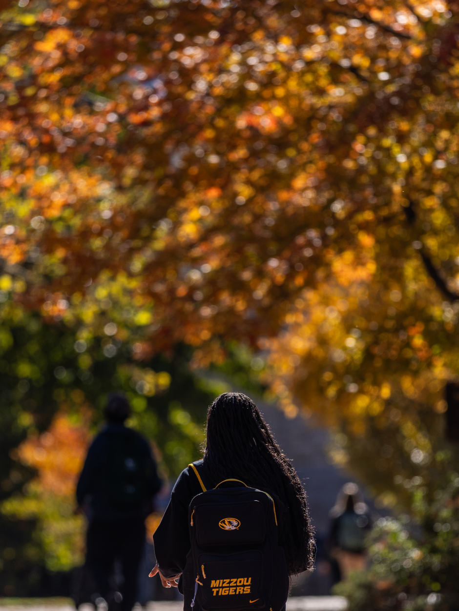 Student with backpack walks