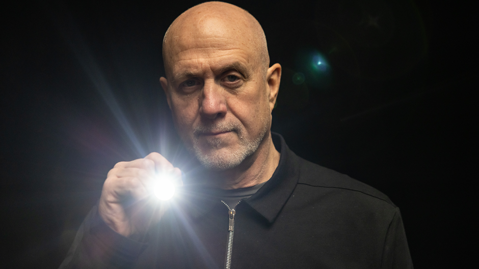 Barry Edwards holding a flashlight.