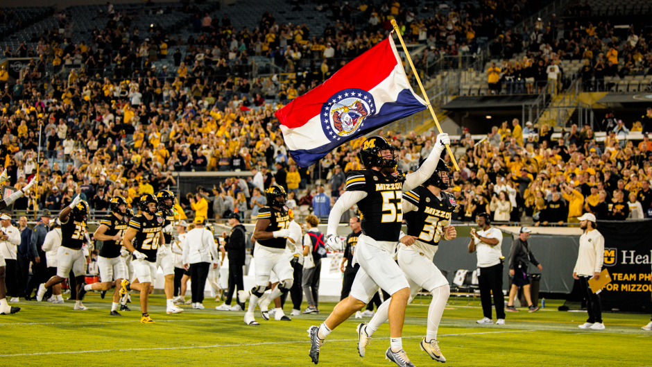 Player runs Missouri flags down the field