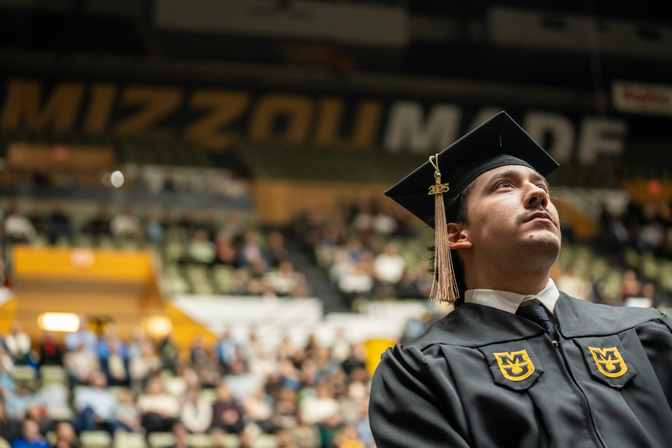 Graduate looks up at stage