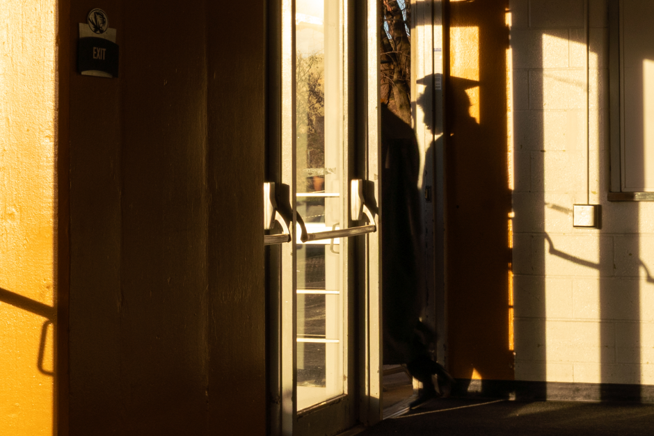 Graduate's shadow projects near door