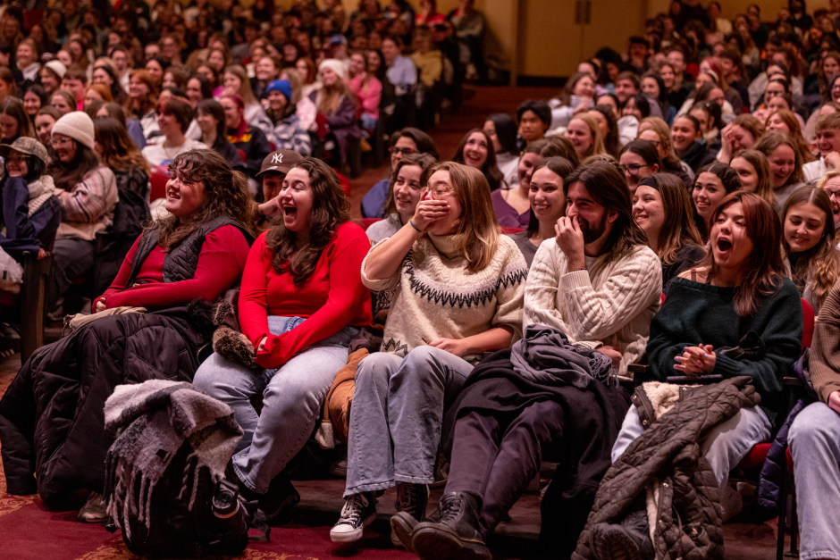 Students in crowd laugh