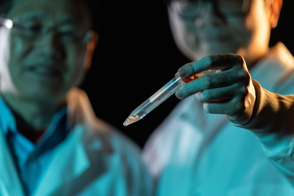 Scientists hold syringe