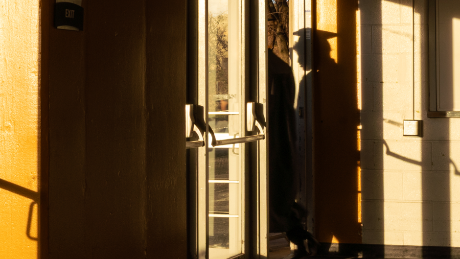 Shadow of graduate next to door