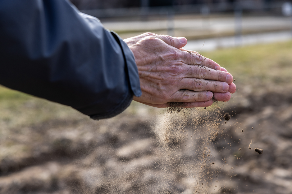 Walter Gassmann holding soil at Sanborn Field.