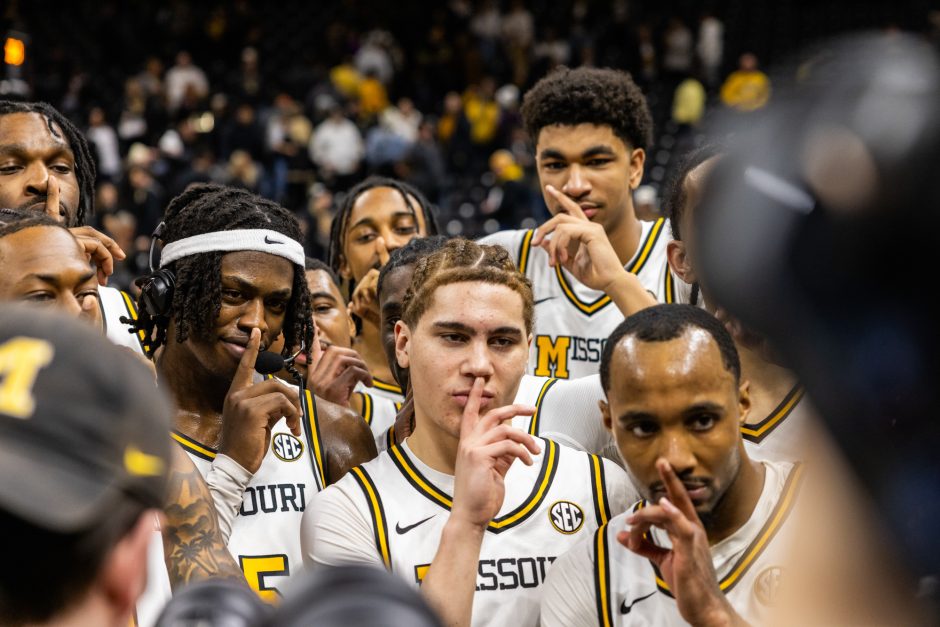 Mizzou basketball players holding finger to their lips to be quiet