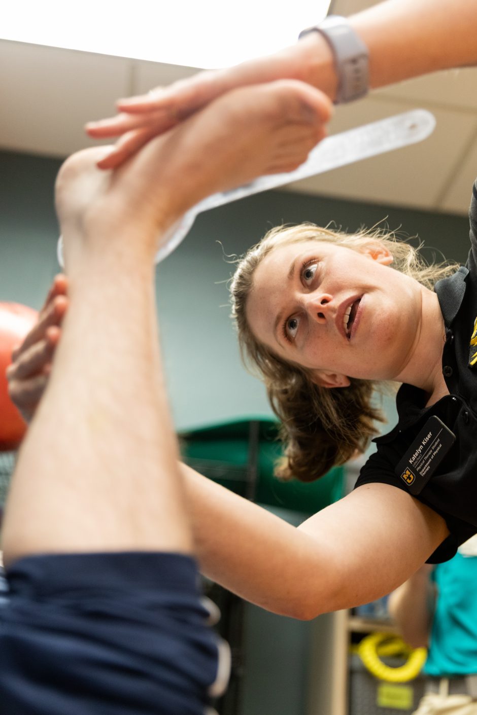 Health Sciences student holds a patient's foot