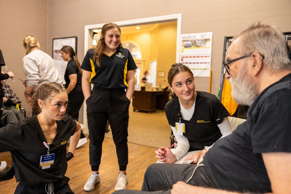 Health Sciences students talking to a patient