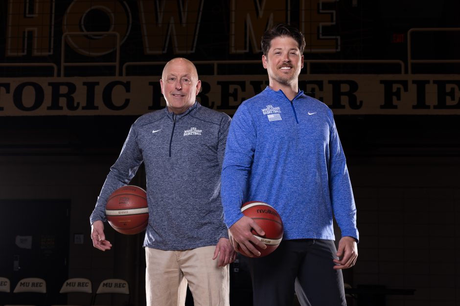 Two people holding basketballs