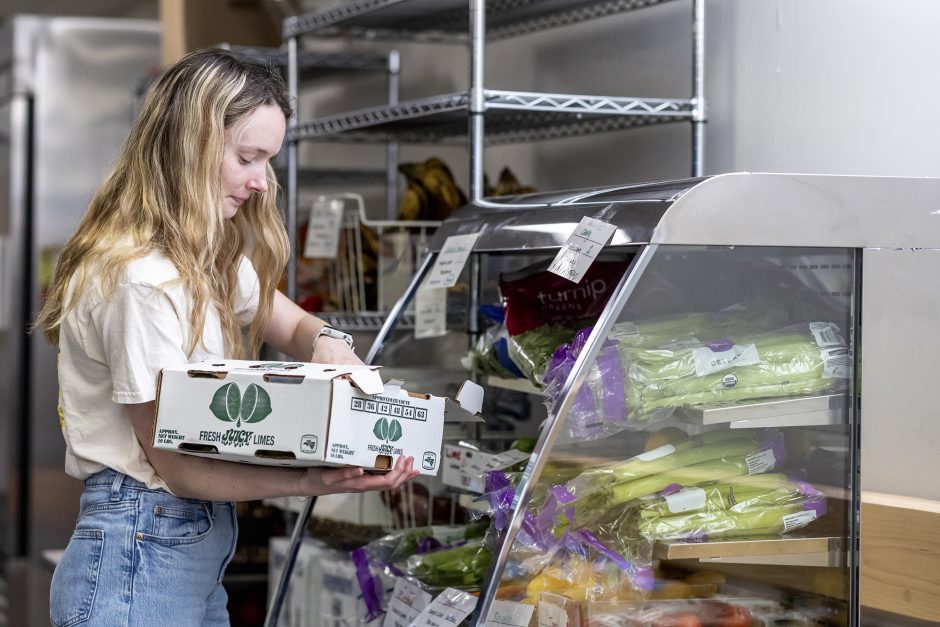 A student organizes groceries at a food pantry.