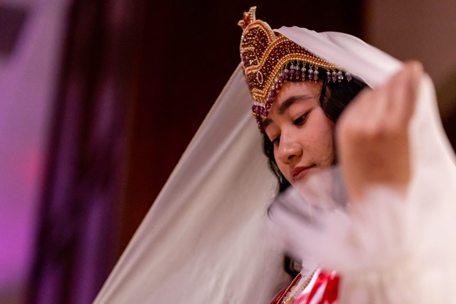 Student moving veil-like material out of face